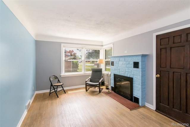 19988 Macarthur St, Redford, MI 48240 - living area with hardwood / wood-style flooring and a fireplace
