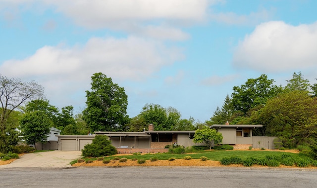 35 Fultonwood Dr SE, Grand Rapids, MI 49503 - view of front of property with concrete driveway, a chimney, and an attached garage