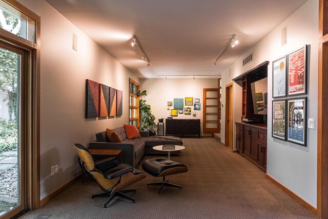 35 Fultonwood Dr SE, Grand Rapids, MI 49503 - living area featuring track lighting, carpet, and baseboards