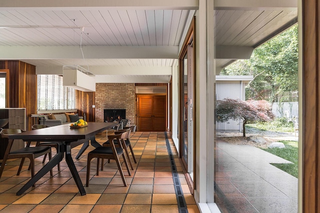 35 Fultonwood Dr SE, Grand Rapids, MI 49503 - dining room with a brick fireplace and wood ceiling with exposed beams