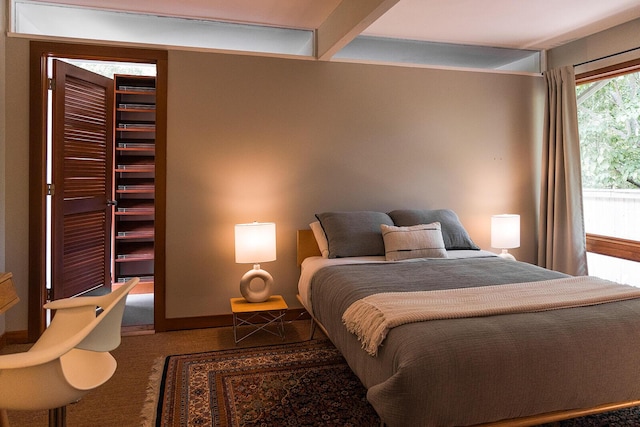 35 Fultonwood Dr SE, Grand Rapids, MI 49503 - carpeted bedroom featuring a spacious closet and beam ceiling