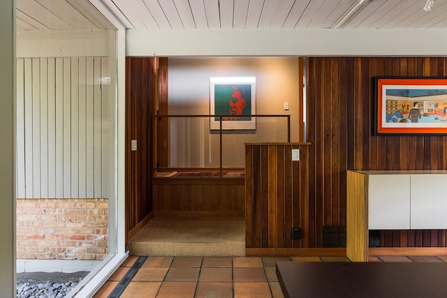 35 Fultonwood Dr SE, Grand Rapids, MI 49503 - hallway with wood walls, wood ceiling, and tile patterned flooring