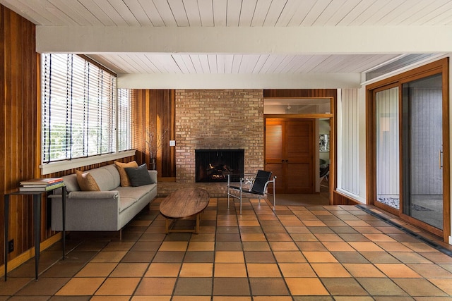 35 Fultonwood Dr SE, Grand Rapids, MI 49503 - living area featuring wood walls, wooden ceiling with exposed beams, a fireplace, and light tile patterned flooring