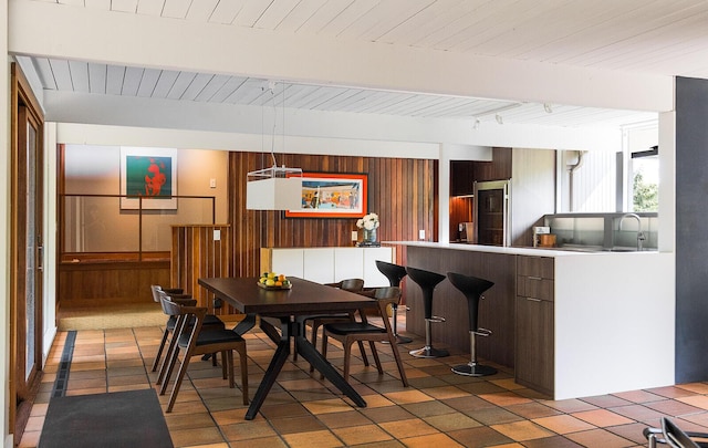 35 Fultonwood Dr SE, Grand Rapids, MI 49503 - dining room with wood walls and wood ceiling with exposed beams