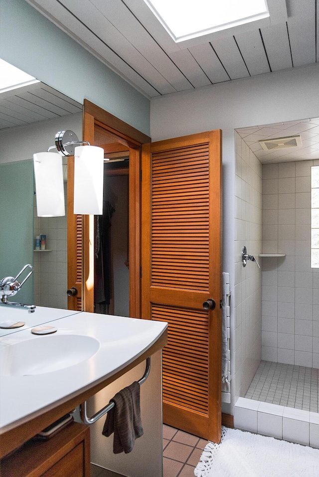 35 Fultonwood Dr SE, Grand Rapids, MI 49503 - full bath featuring a sink, tile patterned flooring, and tiled shower