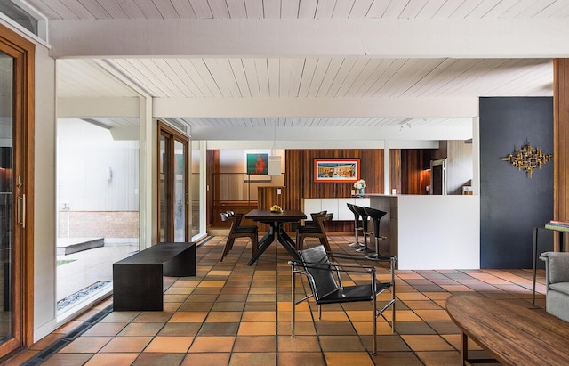 35 Fultonwood Dr SE, Grand Rapids, MI 49503 - dining area with wooden ceiling with exposed beams, wooden walls, and tile patterned floors