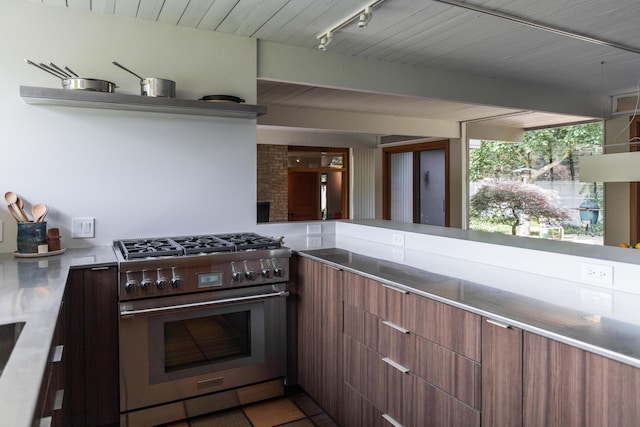 35 Fultonwood Dr SE, Grand Rapids, MI 49503 - kitchen with high end stainless steel range, modern cabinets, light countertops, and beamed ceiling