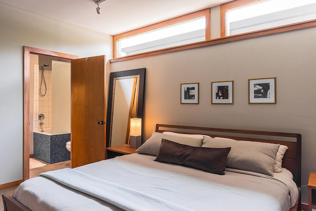 35 Fultonwood Dr SE, Grand Rapids, MI 49503 - bedroom with ensuite bathroom and track lighting