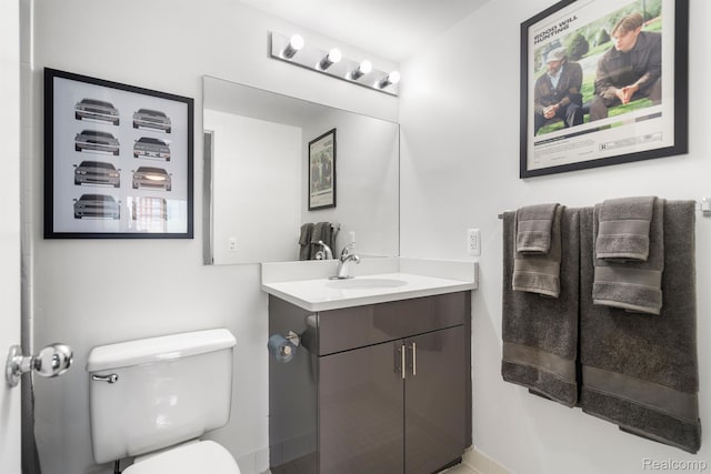 3320 Spinnaker Ln Unit 4A, Detroit, MI 48207 - bathroom featuring vanity, toilet, and baseboards