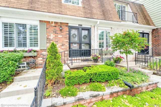 1874 Wickham St Unit 68, Royal Oak, MI 48073 - doorway to property with roof with shingles and brick siding
