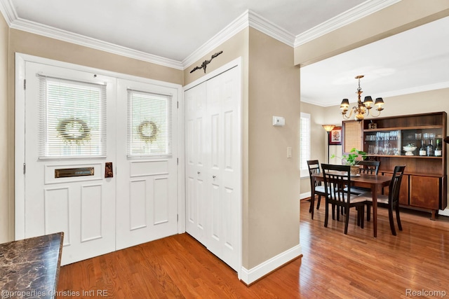 1874 Wickham St Unit 68, Royal Oak, MI 48073 - foyer featuring a chandelier, wood finished floors, healthy amount of natural light, ornamental molding, and baseboards