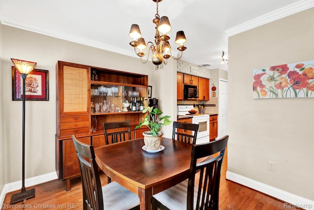 1874 Wickham St Unit 68, Royal Oak, MI 48073 - dining space with a chandelier, baseboards, light wood-style floors, and ornamental molding