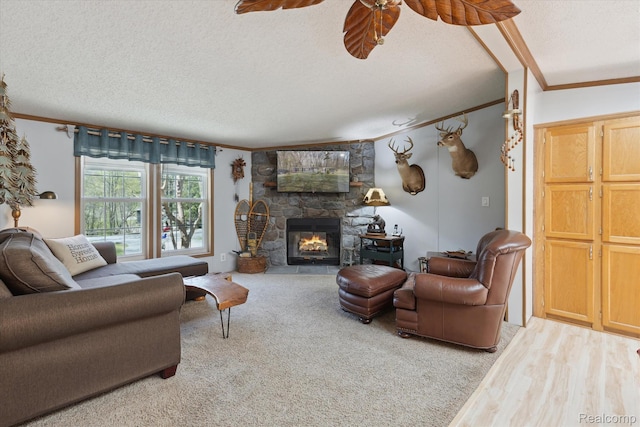4952 Davison Rd, Lapeer, MI 48446 - living area with ornamental molding, a textured ceiling, a ceiling fan, a fireplace, and carpet flooring