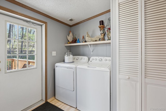 4952 Davison Rd, Lapeer, MI 48446 - laundry area with washer and dryer, crown molding, a textured ceiling, and light wood-style floors