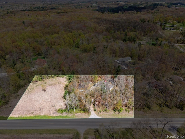 4952 Davison Rd, Lapeer, MI 48446 - aerial view of property and surrounding area featuring a heavily wooded area and property boundaries highlighted