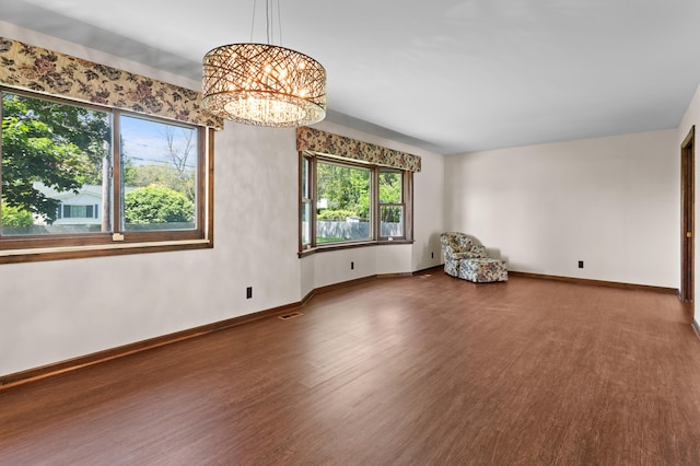 3244 Dearborn St, Wayne, MI 48184 - spare room featuring wood finished floors, a chandelier, and baseboards