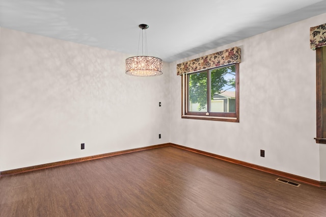 3244 Dearborn St, Wayne, MI 48184 - spare room featuring wood finished floors, baseboards, and a chandelier