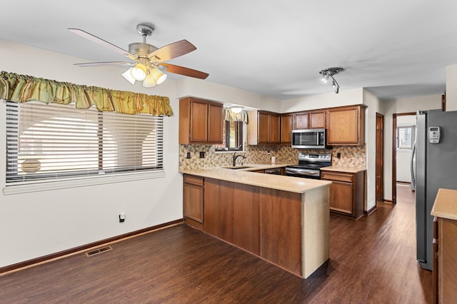 3244 Dearborn St, Wayne, MI 48184 - kitchen with appliances with stainless steel finishes, a peninsula, light countertops, dark wood-style flooring, and a ceiling fan