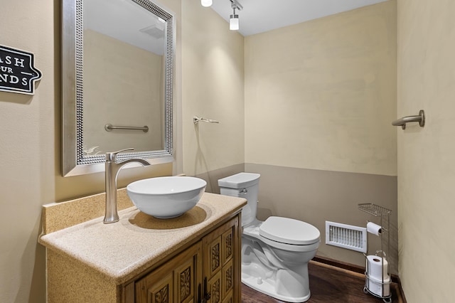3244 Dearborn St, Wayne, MI 48184 - half bathroom featuring toilet, vanity, and wood finished floors