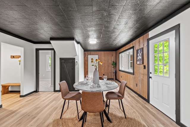 17465 Rapids Dr, Hersey, MI 49639 - dining room with healthy amount of natural light, light wood-style floors, wood walls, and baseboards