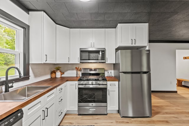 17465 Rapids Dr, Hersey, MI 49639 - kitchen featuring stainless steel appliances, wooden counters, a sink, and light wood-style flooring