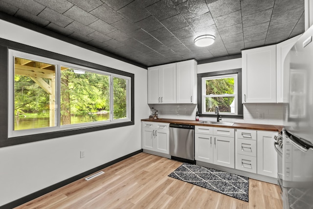 17465 Rapids Dr, Hersey, MI 49639 - kitchen with stainless steel dishwasher, wooden counters, a sink, and refrigerator