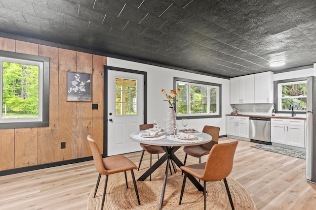17465 Rapids Dr, Hersey, MI 49639 - dining space featuring healthy amount of natural light, light wood-type flooring, and wooden walls