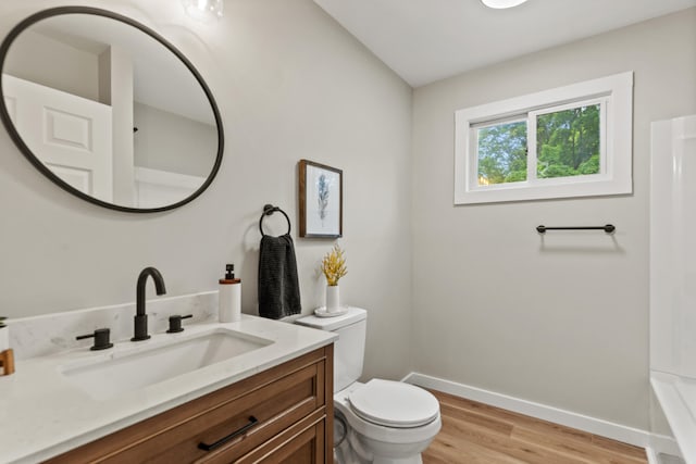17465 Rapids Dr, Hersey, MI 49639 - full bathroom with toilet, wood finished floors, vanity, and baseboards