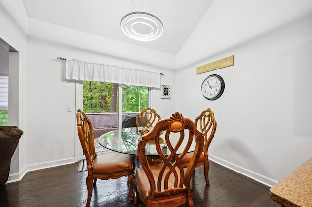 4085 Ravina Ter, Saint Joseph, MI 49085 - dining area with lofted ceiling, baseboards, dark wood-type flooring, and a chandelier