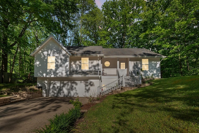 4085 Ravina Ter, Saint Joseph, MI 49085 - view of front facade featuring an attached garage, driveway, a front lawn, and stairway