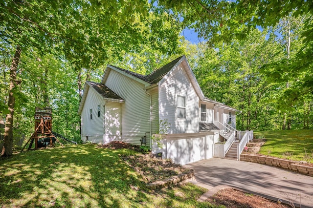 4085 Ravina Ter, Saint Joseph, MI 49085 - view of home's exterior with concrete driveway, stairway, a garage, and a yard