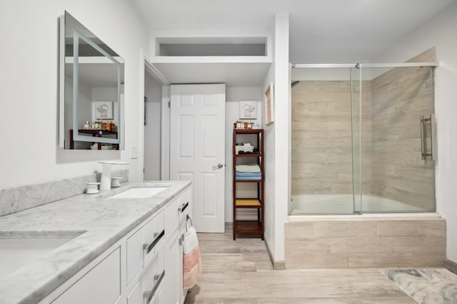 4085 Ravina Ter, Saint Joseph, MI 49085 - full bath with wood finished floors, double vanity, and tiled shower / bath combo