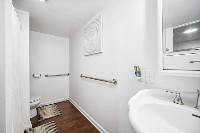 4085 Ravina Ter, Saint Joseph, MI 49085 - bathroom with a sink, toilet, baseboards, wood finished floors, and a shower with shower curtain