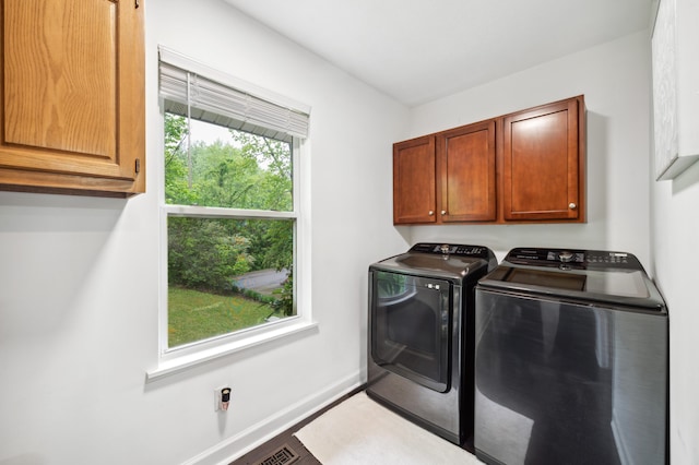 4085 Ravina Ter, Saint Joseph, MI 49085 - washroom featuring independent washer and dryer, cabinet space, and baseboards