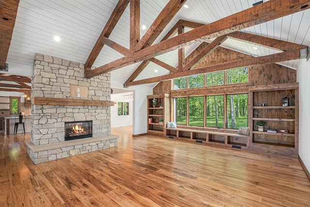 4035 136th Ave, Hamilton, MI 49419 - unfurnished living room featuring high vaulted ceiling, a fireplace, wood-type flooring, and wood ceiling with exposed beams