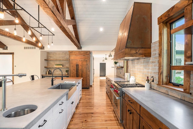 4035 136th Ave, Hamilton, MI 49419 - kitchen featuring stainless steel stove, a sink, backsplash, light wood finished floors, and beamed ceiling