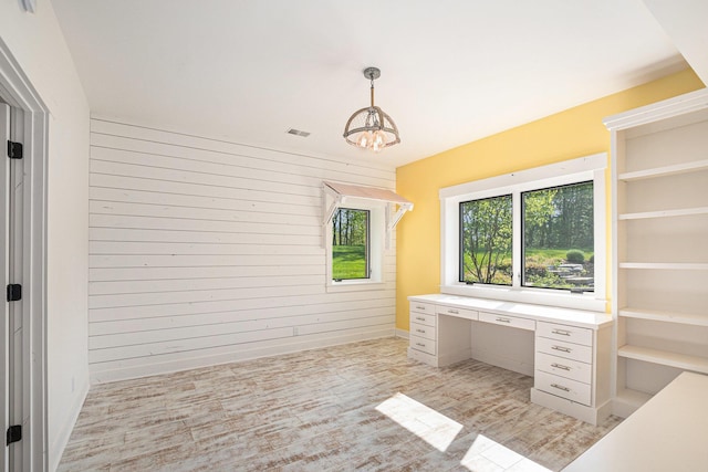 4035 136th Ave, Hamilton, MI 49419 - unfurnished office with a chandelier, wooden walls, and light wood-type flooring