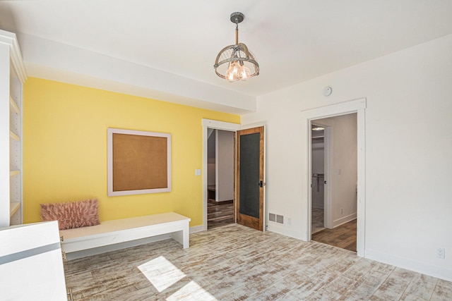 4035 136th Ave, Hamilton, MI 49419 - unfurnished bedroom featuring wood finished floors, a chandelier, baseboards, and a spacious closet