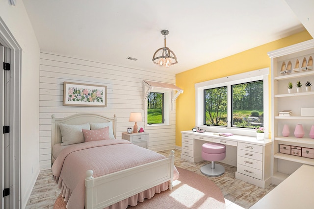 4035 136th Ave, Hamilton, MI 49419 - bedroom with an office area, wooden walls, light wood-type flooring, and a chandelier