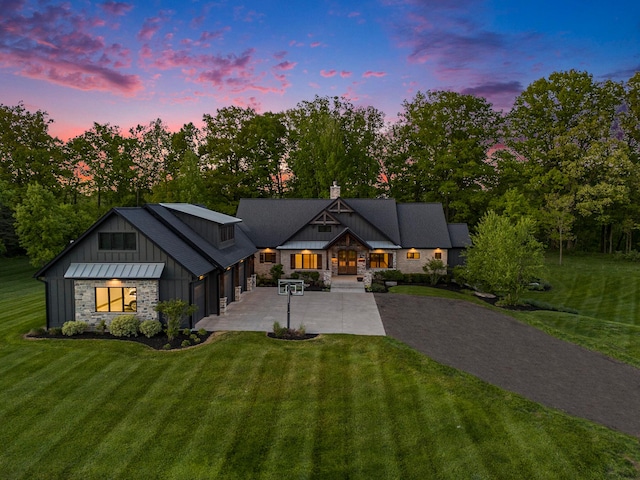 4035 136th Ave, Hamilton, MI 49419 - modern farmhouse style home featuring driveway, board and batten siding, a front lawn, and stone siding
