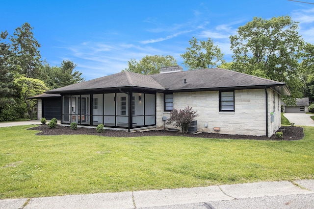 906 Wilshire Blvd, Kalamazoo, MI 49008 - view of front of property with a front lawn, stone siding, a garage, and a shingled roof