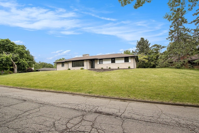 906 Wilshire Blvd, Kalamazoo, MI 49008 - view of front of home featuring a front lawn and a chimney