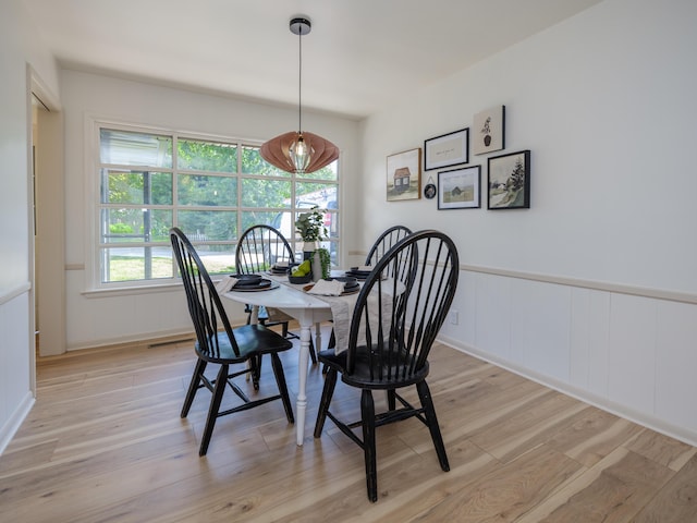 906 Wilshire Blvd, Kalamazoo, MI 49008 - dining room with a decorative wall, light wood-type flooring, and a wainscoted wall