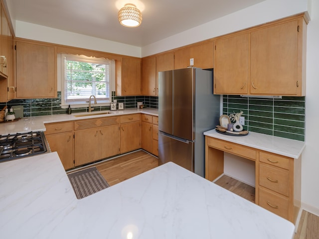 906 Wilshire Blvd, Kalamazoo, MI 49008 - kitchen featuring stainless steel appliances, light countertops, decorative backsplash, and light wood finished floors