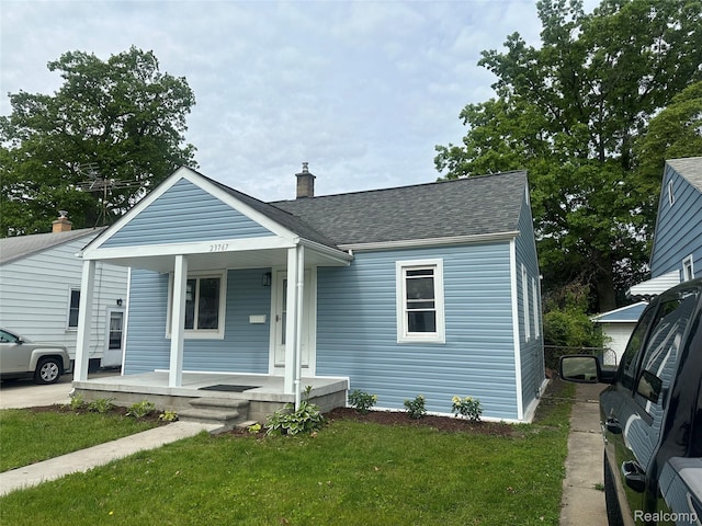 23767 Battelle Ave, Royal Oak, MI 48030 - bungalow-style house with covered porch, a chimney, a front lawn, and a shingled roof
