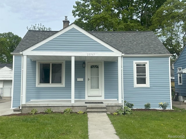 23767 Battelle Ave, Royal Oak, MI 48030 - bungalow featuring a porch, a shingled roof, a chimney, and a front lawn
