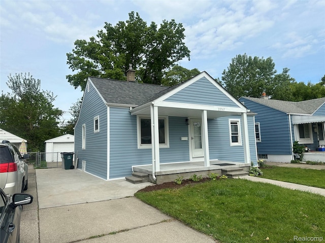 23767 Battelle Ave, Royal Oak, MI 48030 - bungalow-style home featuring covered porch, roof with shingles, an outbuilding, a chimney, and a garage