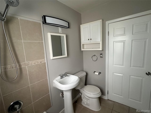 23767 Battelle Ave, Royal Oak, MI 48030 - bathroom featuring tile patterned flooring, a tile shower, toilet, and baseboards