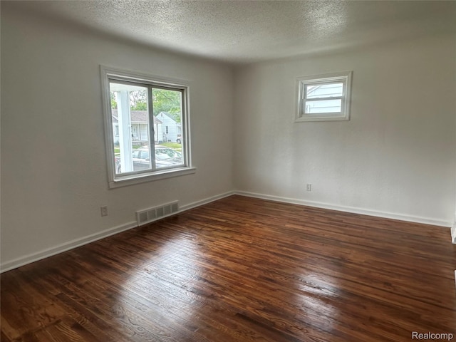 23767 Battelle Ave, Royal Oak, MI 48030 - spare room featuring dark wood finished floors, a textured ceiling, and baseboards
