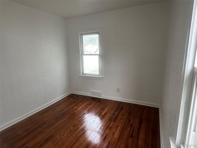 23767 Battelle Ave, Royal Oak, MI 48030 - empty room featuring baseboards, dark wood-type flooring, and a textured wall